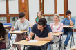 Students sitting at the exam room writing