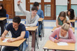 Boy raising hand during exam