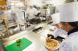 Cooks preparing pizza