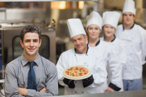 Photo: Waiter standing in front of Chef's Waiter standing in front of Chef's