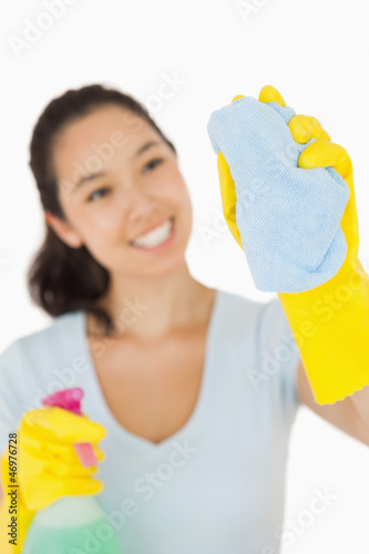 Photo: Happy woman cleaning a window Happy woman cleaning a window