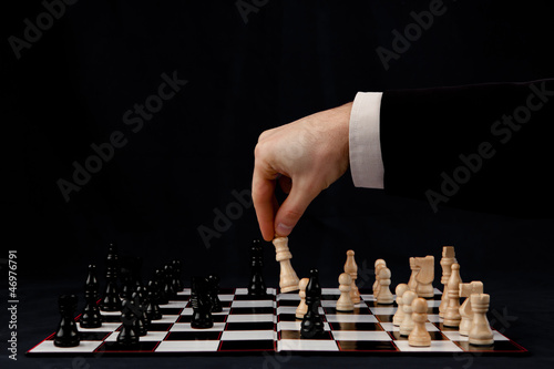Photo: Person playing chess Person playing chess
