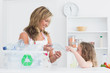 Mother sorting waste with her daughter