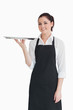 Foto: Smiling woman holding an empty silver tray Smiling woman holding an empty silver tray