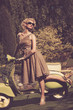 Woman in retro dress with a scooter