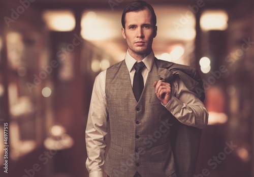 Photo: Man in waistcoat with against blurred background Man in waistcoat with against blurred background