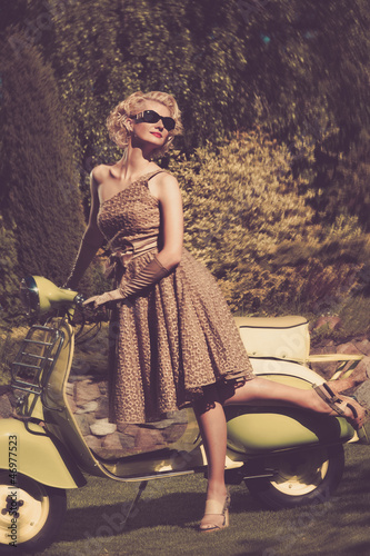 Photo: Woman in retro dress with a scooter Woman in retro dress with a scooter