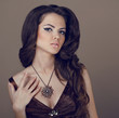Brown Hair Styling. Beautiful Woman with Healthy Long Hair