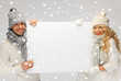 couple in a winter clothes holding blank board