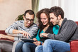 Three Friends with Tablet PC on a Sofa