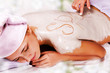 Young woman with slimming body thermal mask on her back. Spa Tre