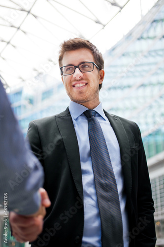 Photo: Outdoor businessmen handshake Outdoor businessmen handshake