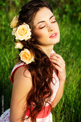 Photo: Beautiful woman with flowers in her hair Beautiful woman with flowers in her hair