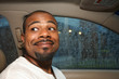 Cute smiling African American man in car