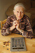 Photo: Portrait of senior woman with money and calculator Portrait of senior woman with money and calculator
