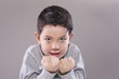 Boy makes fists.