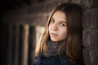 Teenage girl against a brick wall