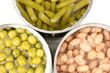 Open tin cans of french bean, beans and peas isolated on white
