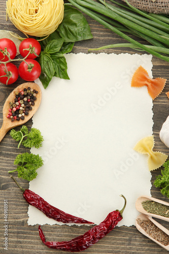 Photo: paper for recipes vegetables, and spices on wooden table paper for recipes vegetables, and spices on wooden table