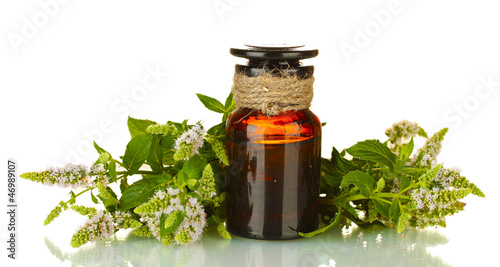 Photo: Essential oil and mint isolated on white Essential oil and mint isolated on white