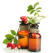 medicine bottles with hip roses, isolated on white