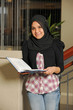 Young Eastern Student holding a book