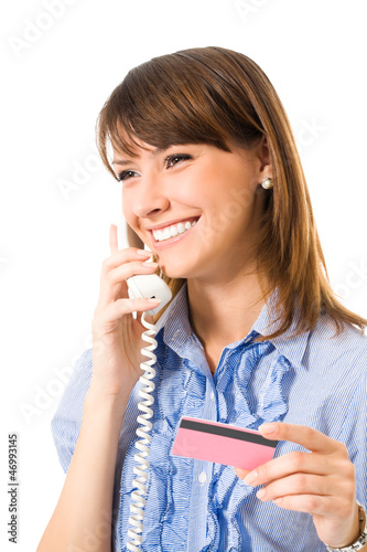 Photo: Young businesswoman with plastic card, on phone Young businesswoman with plastic card, on phone