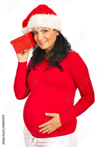 Photo: Pregnant woman listening to Xmas gift Pregnant woman listening to Xmas gift