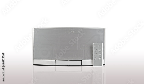 Photo: audio speaker on white background with remote control audio speaker on white background with remote control