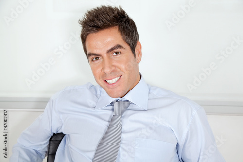 Photo: Young Businessman Relaxing In Office Young Businessman Relaxing In Office