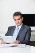 Businessman Using Digital Tablet At Desk