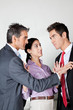 Businesswoman Acting As Peacemaker Between Colleagues