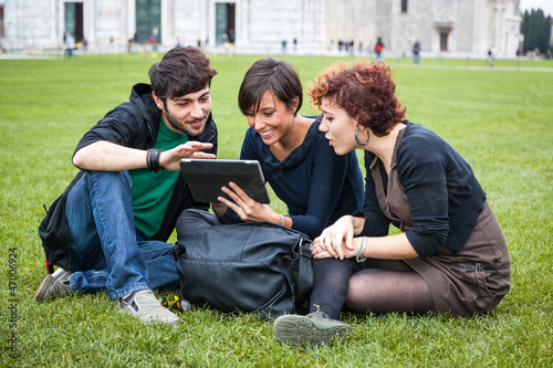 Photo: Group of Friends with Tablet PC Outside Group of Friends with Tablet PC Outside