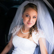 Portrait of a beautiful young bride waiting in the car