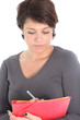 Woman concentrating writing notes