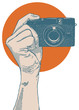 Hand holding small point and shoot camera