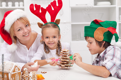 Photo: Woman and her kids decorating christmas cookies Woman and her kids decorating christmas cookies
