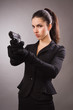 Spy girl in a black shoots a gun