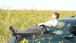 Businessman Relaxing in Sunflower Field on Tablet