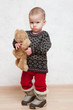 Baby in winter clothes with toy
