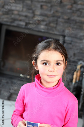 Photo: Little girl playing card game alone Little girl playing card game alone