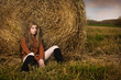 Beautiful woman near a haystack