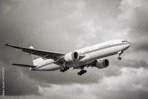 Photo: sepia toned unmarked passenger aircraft landing sepia toned unmarked passenger aircraft landing