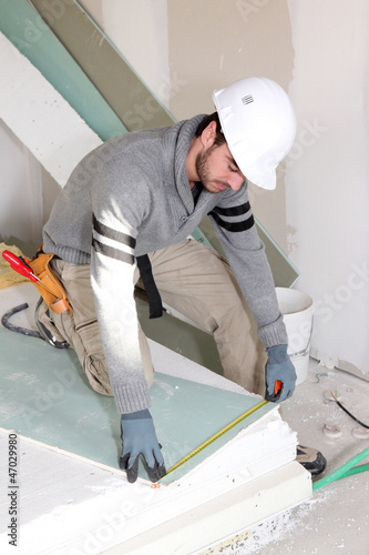 Photo: Man installing wall panels Man installing wall panels