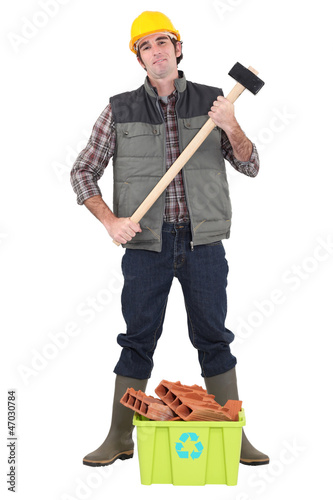 Photo: Worker stood with box of recyclable debris Worker stood with box of recyclable debris