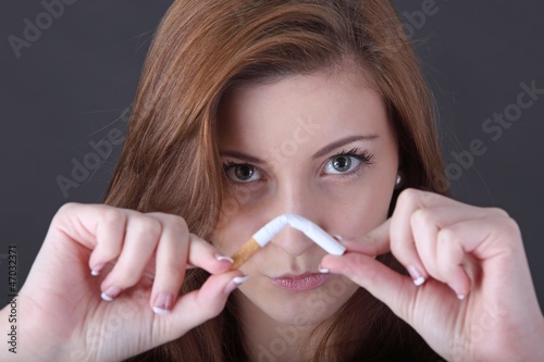 Photo: woman and stop smoking cigarette (focus on face) woman and stop smoking cigarette (focus on face)