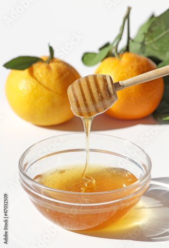 Photo: Honey and Mandarins isolated on white Honey and Mandarins isolated on white