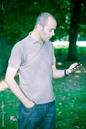 Photo: Man with Mobile Phone at Park Man with Mobile Phone at Park