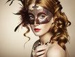 Photo: Beautiful young woman in brown mysterious venetian mask Beautiful young woman in brown mysterious venetian mask