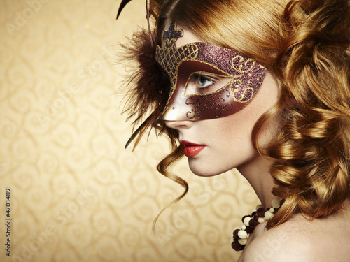 Photo: Beautiful young woman in brown mysterious venetian mask Beautiful young woman in brown mysterious venetian mask